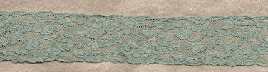 Flowery machine lace with gimp on one side