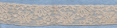Flowery machine lace with gimp on one side
