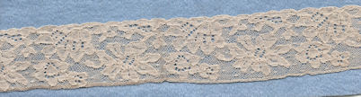 Flowery machine lace with gimp on one side