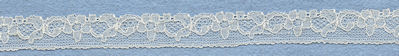 Flowery machine lace with gimp on one side