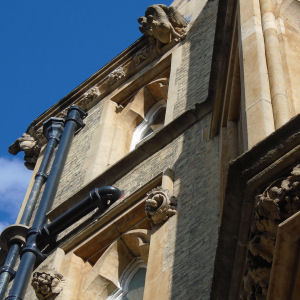 Gargoyles above grasshopper on clock